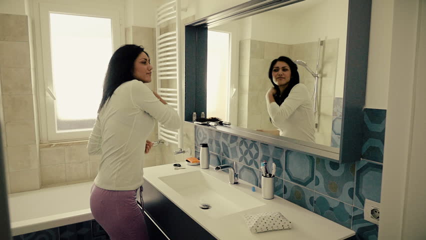 Cute happy girl dancing in the bathroom in the morning slow motion medium shot