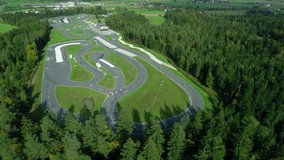 In this video, we can see the plan of the car racing track. There is a beautiful scenery in the background: woods and valleys. Wide-angle shot.
