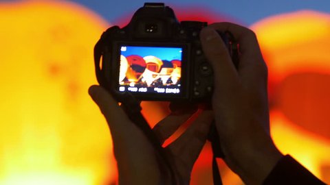 Taking video with camera during 2015 Bristol Balloon Fiesta - night show Stock Video