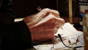hands of elderly man doing crossword puzzles or sudoku - Powered by Shutterstock - Get 15% off with code: PIKWIZARD15