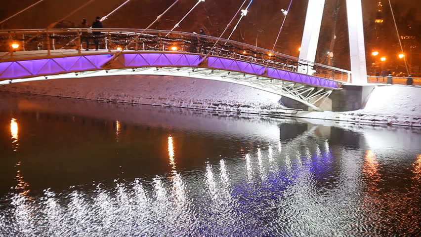 illuminated bridge at night in a city park