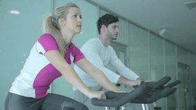 Different intensity by using indoor cycles. There are some different intensity of training in the video. People use indoor bike trainers in the gym with different exercise intensity.