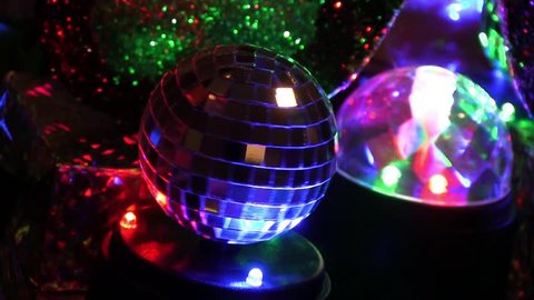Miniature Mardi Gras disco ball spinning around next to other table decorations