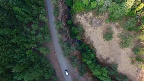 Classic VW Bus Drives Next Down To River - Aerial 4k - Drone