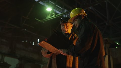 Engineer and Worker Have Conversation in Foundry. Industrial Environment. Middle Shot. Shot on RED Cinema Camera in 4K (UHD).