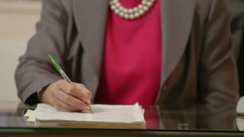 Shallow DOF of a businesswoman editing or marking up a document