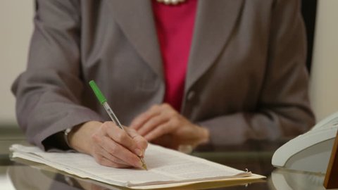 Shallow DOF of attorney editing or marking up a legal document by hand