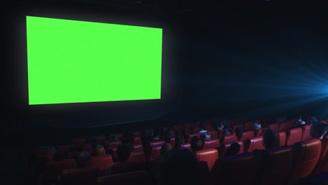 Group of people are watching a green screen mock-up film screening in a movie cinema theater. Shot on RED Cinema Camera in 4K (UHD).