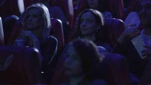 Group of people are watching a film screening in a movie cinema theater. Shot on RED Cinema Camera in 4K (UHD).