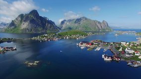 Aerial footage of picturesque town Reine on norwegian Lofoten islands, popular tourist destination on sunny summer day. Aerial 4k Ultra HD.