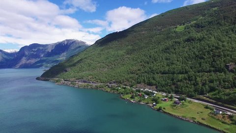 Aerial scenic view of fjord Aurlandsfjorden in Norway with tall mountains surrounding the water. Aerial 4k Ultra HD.