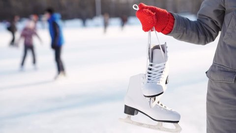 ice skating winter woman holding ice skates outdoors in snow.  : vidéo de stock