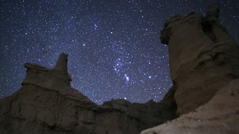 3 axis motion controlled time lapse footage with dolly right, pan right, tilt up & zoom out motion of Constellation Orion moving across Sandstone Formation in Mojave Desert, California