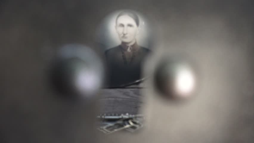 Spying through the keyhole an 1877 vintage family photo overlooks a mysterious black leather trunk with skeleton keys atop.