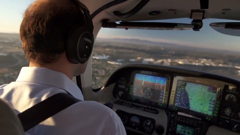 Commercial Airplane Pilot Flying at Sunset View. Pilot Observes The Digital Airplane Dashboard.