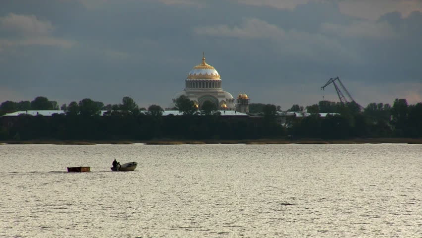 boat floats on the background of the Naval Cathedral of St. Nicholas