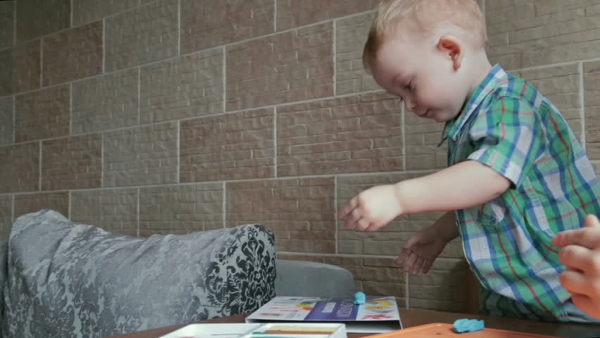 Mother and son playing with plasticine