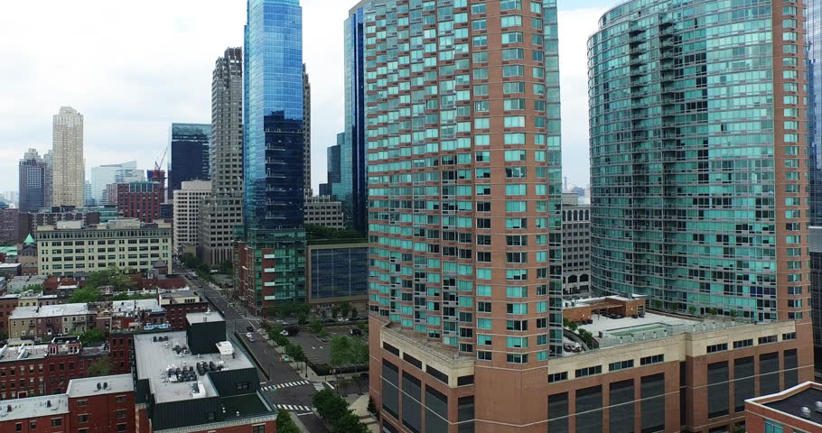 Glass towers of the Jersey City waterfront rising over older brick blocks, 2015.