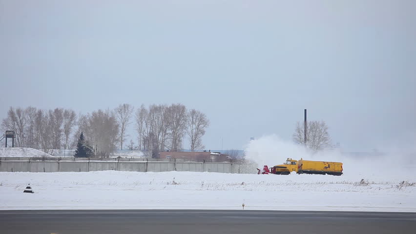 Snowplow clears the runway