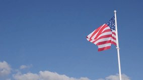 Silky American flag fabric in slow motion waving on the wind 1920X1080 HD footage - United States of America flag against blue sky flowing slow-mo 1080p FullHD video