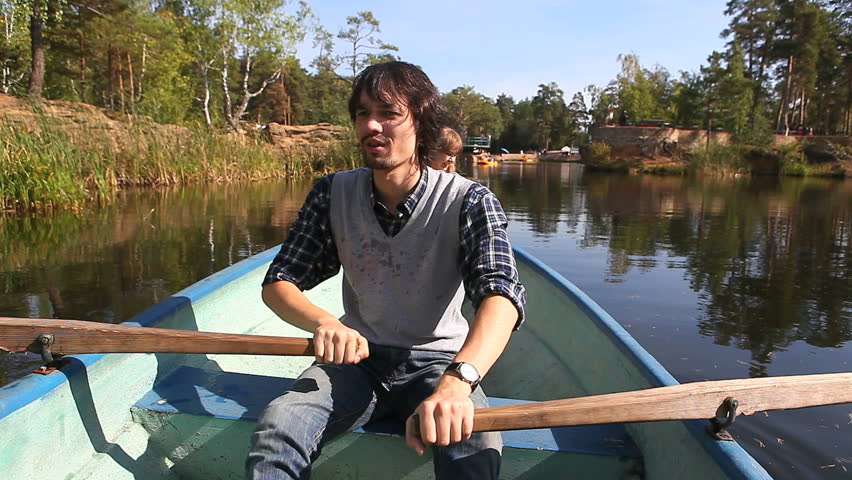 guy on a boat engaged in rowing