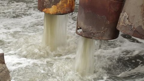 Water Pollution From The Big City. Industrial pipe discharging liquid waste. 