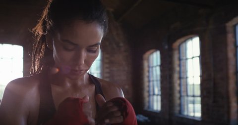 Beautiful Kickboxing woman training punching bag in fitness studio fierce strength fit body slow motion kickboxer series