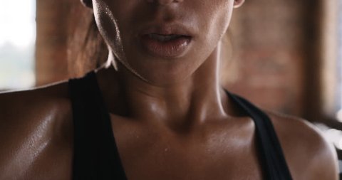 Beautiful Kickboxing woman training wiping sweat in fitness studio fierce strength fit body slow motion Stockvideó