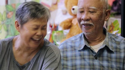 Happy asian senior man and woman using smart phone together,with smile face . Stock Video