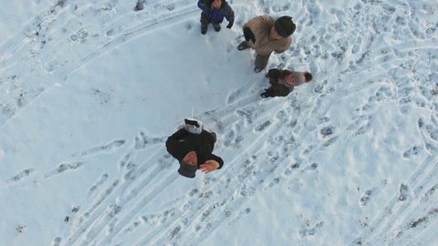 Fathers and kids having fun in winter, aerial view