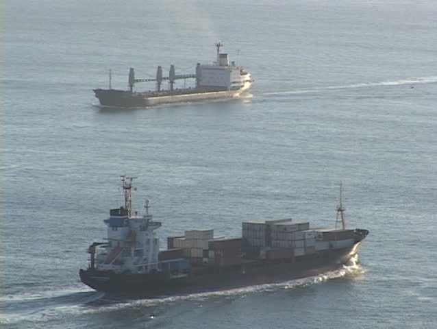 cargo ships pass on the ocean.