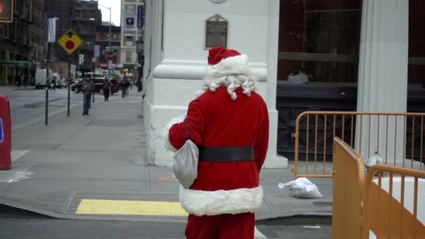 NEW YORK - DEC 20, 2015: drunk Santa Claus man walking in slow motion, 1080p in NY. The holidays bring many red costumes to the streets of Manhattan.
