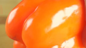 Slicing orange pepper with sharp white knife. Macro video