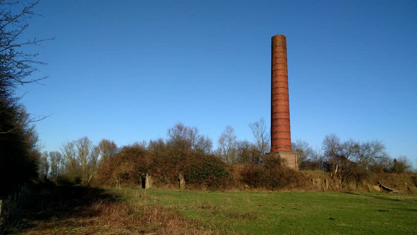 Overgrown brick mill in Dutch river landscape.BLAUWE KAMER, THE NETHERLANDS