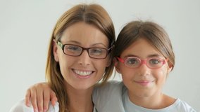 Portrait of mother and daughter with eyeglasses