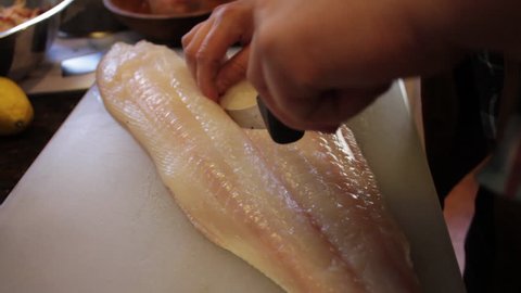 close-up of white fish being cut in half
