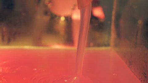 From the hose follows a thick pink substance. The pumping mechanism of thickly solution with ball valve in chemical lab allows the liquid to be pumped in one direction Stockvideo