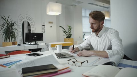 Handsome businessman working at the office and looking at photo frame
