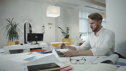 Attractive business man working at the office and looking at photo frame