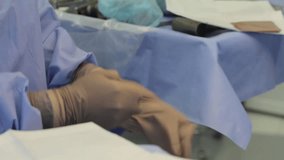 Wearing surgical gloves

Nurse wears surgical gloves and helps to wear gloves to the surgeon (CU)