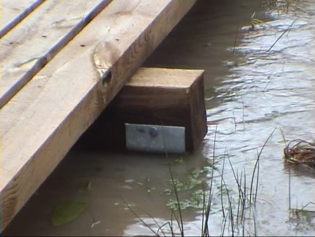 Wooden bridge covered by flood, details