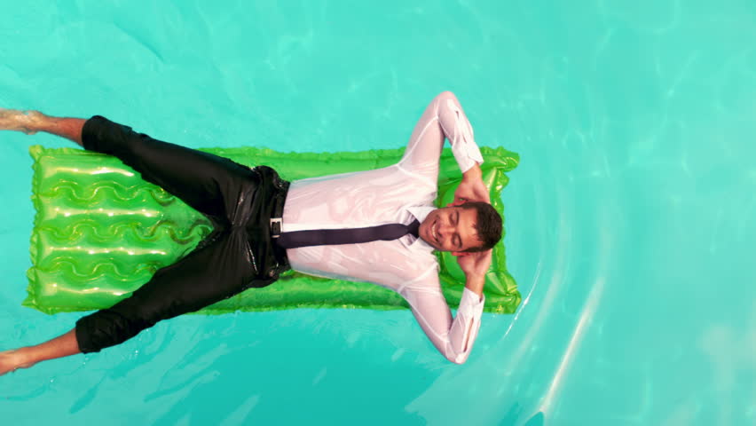 Wet Mixed race businessman relaxing on inflatable in slow motion Royalty-Free Stock Footage #13804370