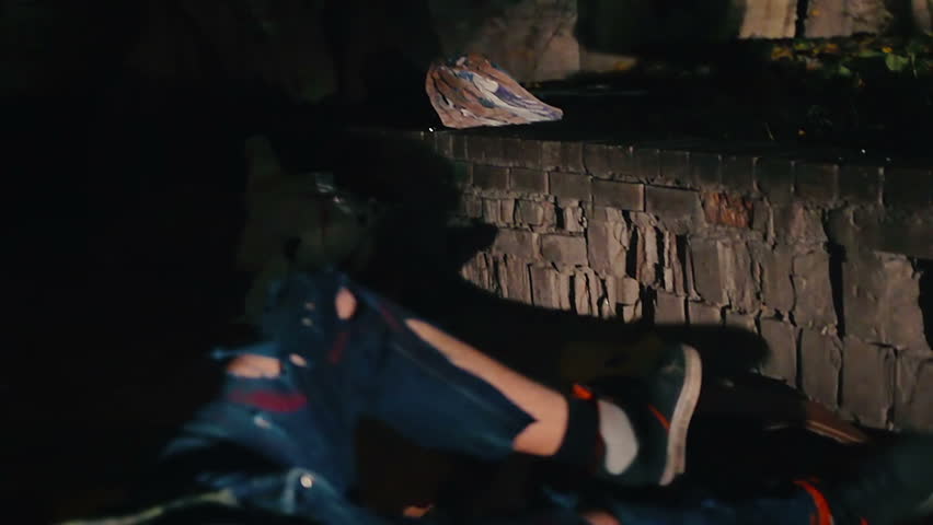 Junkies barely moving in darkness, drug addiction problem, hangover after party