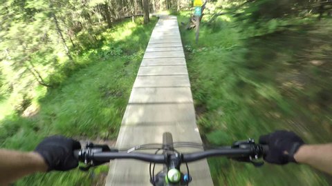 FIRST PERSON VIEW POV: Extreme downhill biker riding on wooden bike trail track