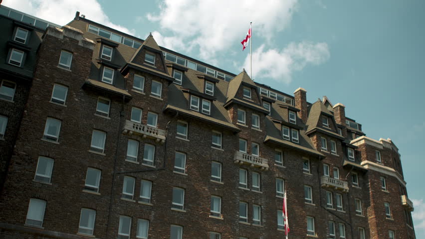 Banff Springs Hotel in Banff, Alberta Canada with red flowers in the foreground.