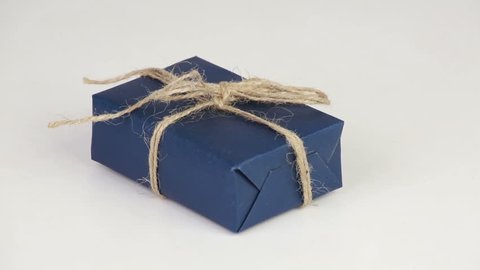 Gift box covered with blue wrapping paper