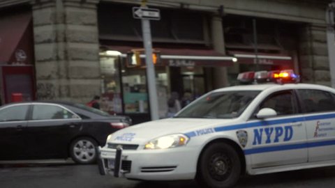 NEW YORK - DEC 25, 2015: NYPD police squad car with flashing lights and siren driving down Broadway in NoHo 1080p HD NYC. North of Houston borders with Greenwich Village in Lower Manhattan.