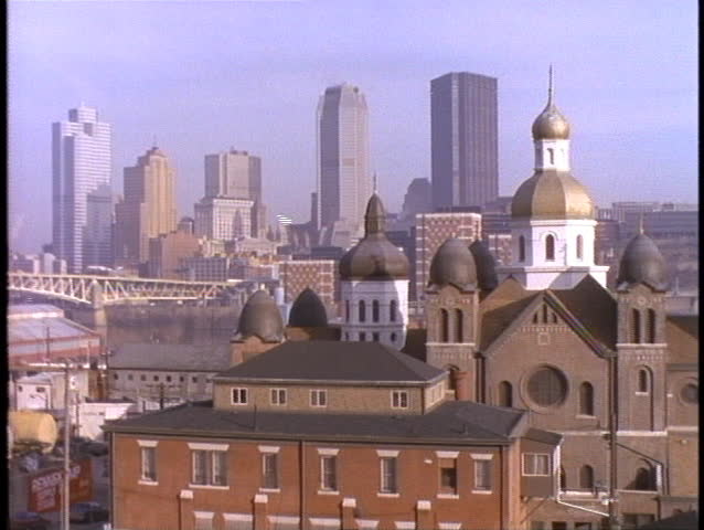 A church stands out in front of the Pittsburgh skyline.