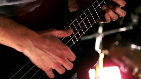 Close up of man playing the bass in slow motion