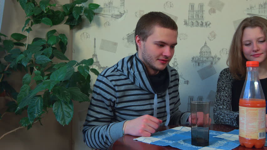 Young couple tries delicious orange juice (slider).